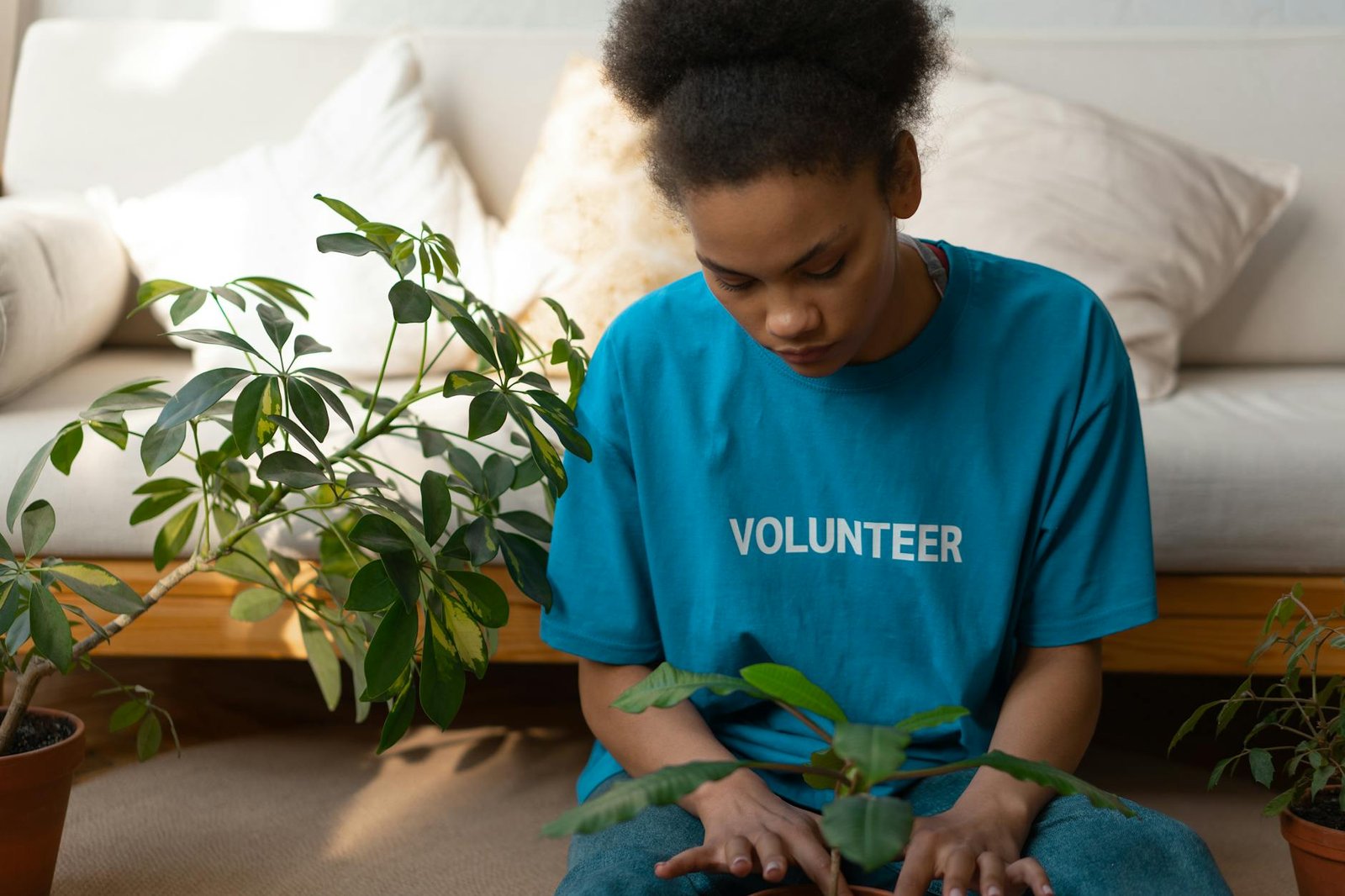 boy in blue crew neck t shirt sitting on blue bed